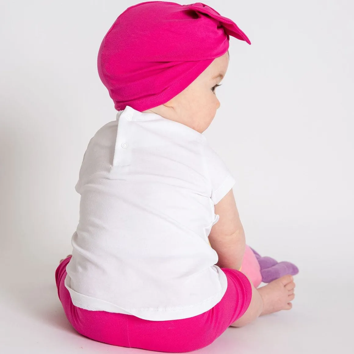 Berrettino in jersey fucsia da bambina