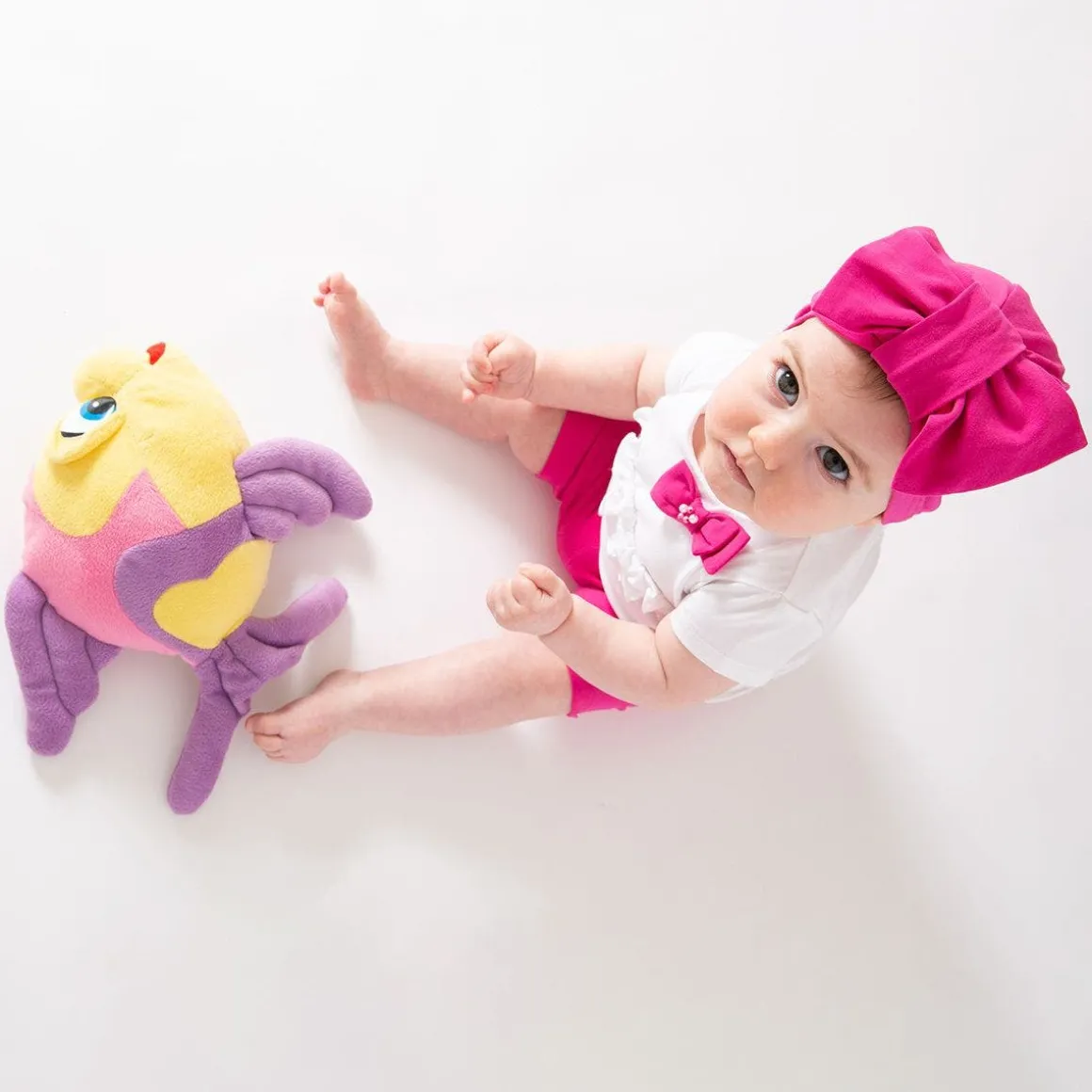 Berrettino in jersey fucsia da bambina