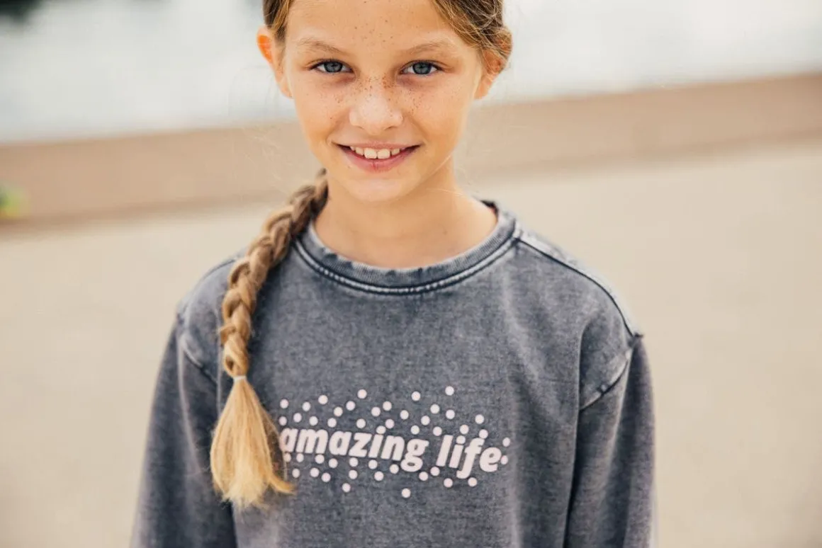 Maglia slavata a maniche lunghe per bambina
