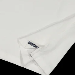 Polo da bambino elegante in piquet bianco.